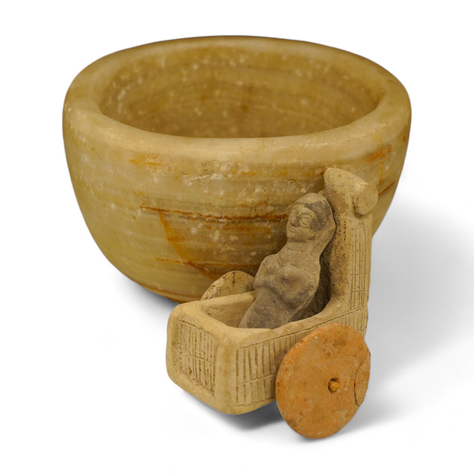 An alabaster mortar, possibly Ancient Egyptian, 17cm diameter, the handles ground off and a terracotta figure with chariot, possibly Mesopotamian. Condition - fair, restoration to chariot